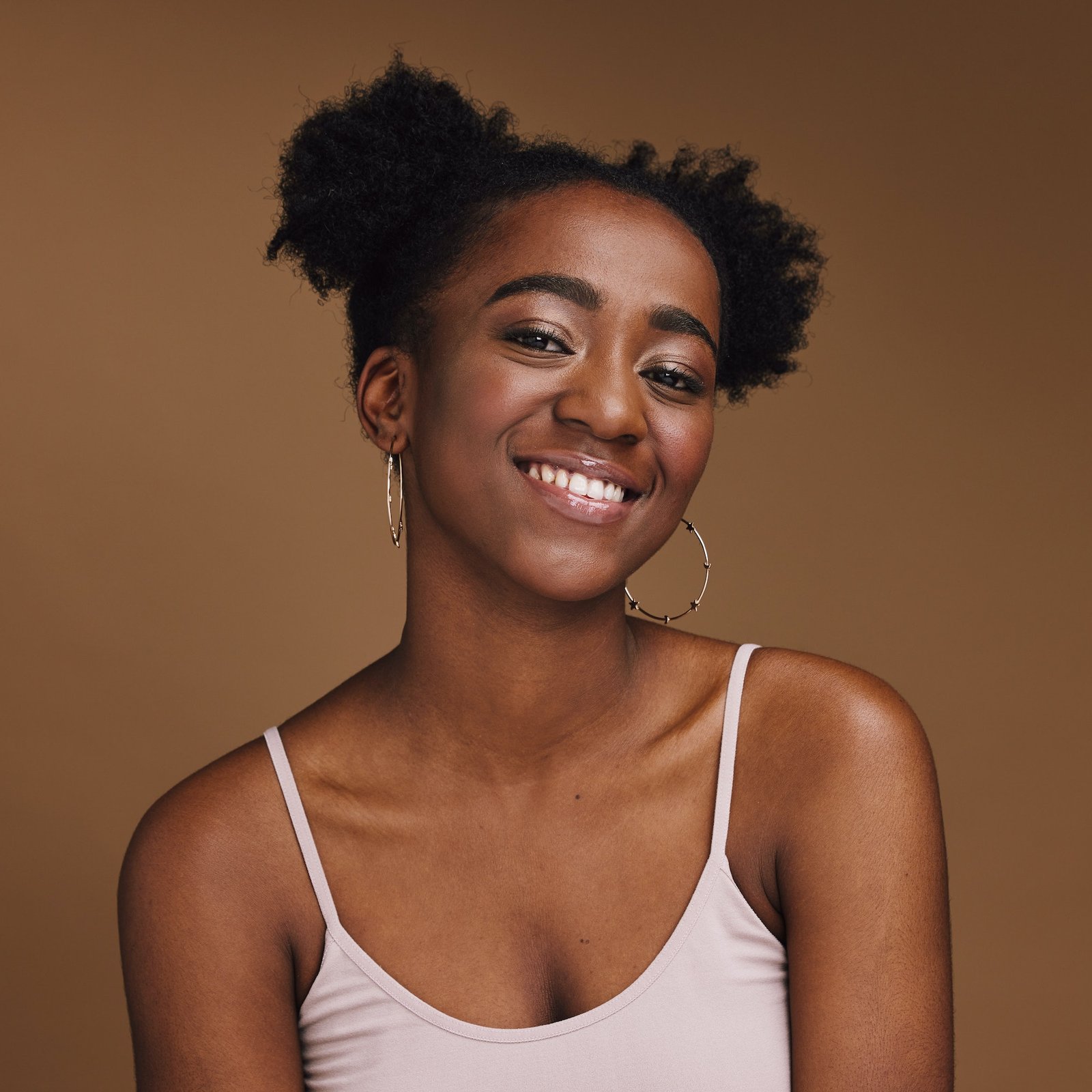 Black Woman Smile And Student Portrait Of A Gen Z Person With Makeup And Jewelry In A Studio Isol.jpg